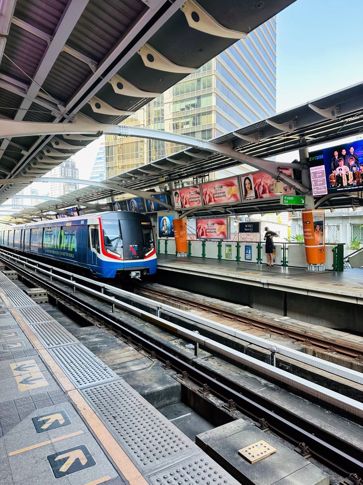 A BTS Skytrain arriving at an elevated station