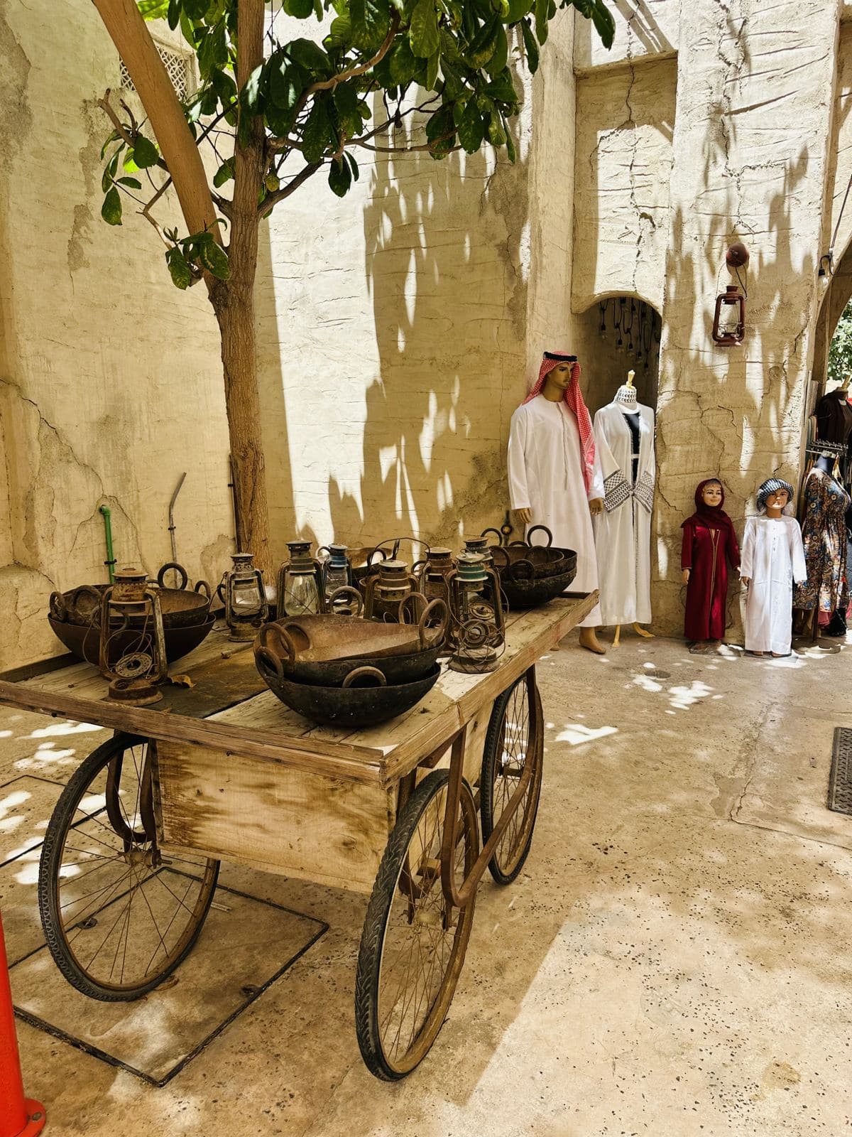 A vintage cart and pots displayed in the heritage quarter
