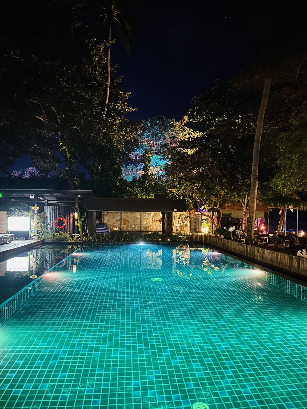 The pool glowing turquoise at night