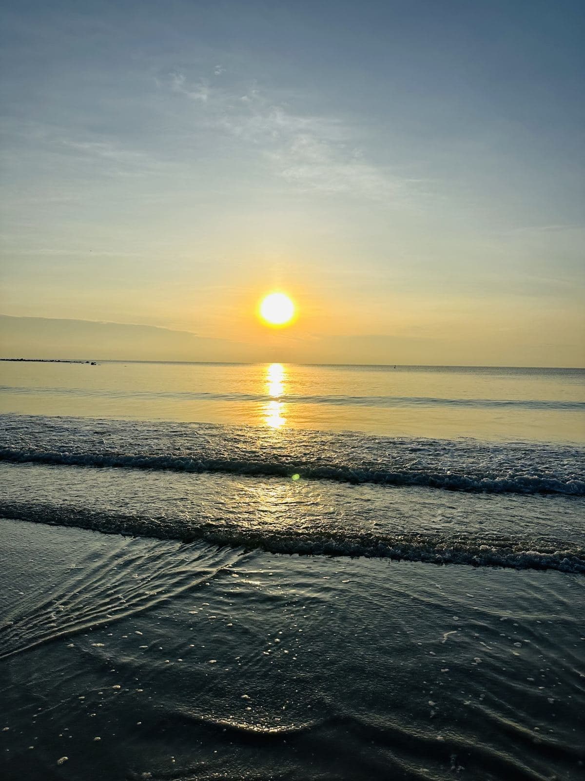 The sun clearing the horizon over a calm sea