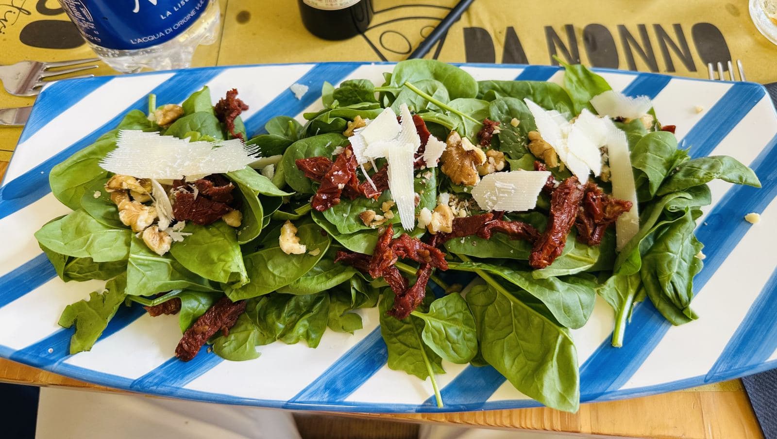 A salad with sun-dried tomatoes and parmesan